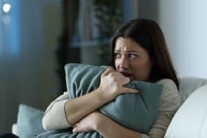 A lady scared when she hears her roof creaking
