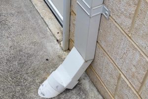 Metal downpipe going into a soak well