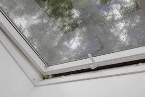 Rain falling on a skylight that is slightly opened
